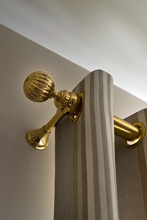 Closeup of gold curtain hardware